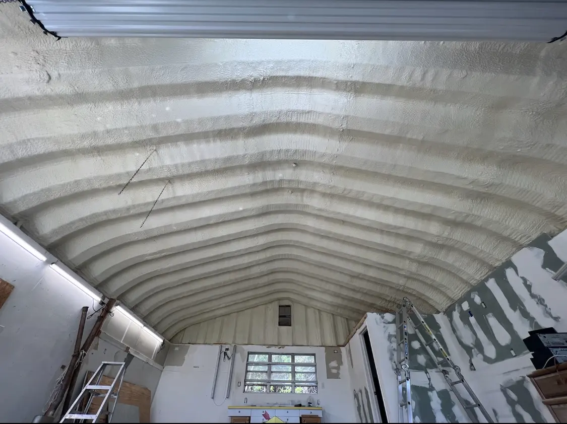 Spray polyurethane foam applied to the underside of a metal roof deck in Sand Springs